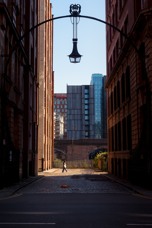 A quiet figure near a classic entranceway by Jukka Heinovirta